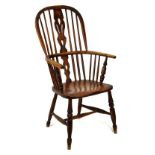 19th Century ash framed stick back Windsor elbow chair raised on turned supports, united by a