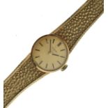 Lady's 9ct gold Omega wristwatch, the gilt dial with baton markers to a textured flexible bracelet