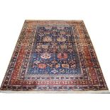 20th Century carpet having geometric motifs against a blue ground within multi border, approx