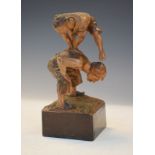 Early 20th Century Black Forest figure group of children playing leap-frog on square plinth, 21cm