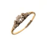 Solitaire diamond set dress ring with diamond points to the shoulders, the shank stamped 18ct and