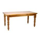 Modern yellow pine refectory style dining table with rounded oblong top on four turned supports,