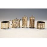 Silver five piece cruet set of twelve sided design comprising a pair of tall cylindrical