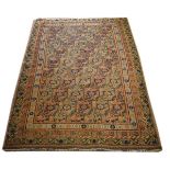 Mid 20th Century rug having geometric floral motifs within a multi border on a brown ground,