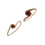 Two dress rings set garnet stones, one stamped 9ct Condition: