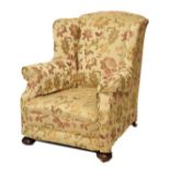 20th Century wing back easy chair with floral decorated sage green silk damask on turned bun feet