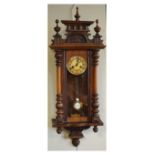 Late 19th Century walnut and beech cased Vienna style wall clock having carved cresting and grid-