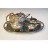 Early 20th Century hammered pewter finish four person tea set with matching oval tray, the base