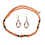 Pink coral necklace of rope twist design, together with a pair of loop earrings en-suite in box of