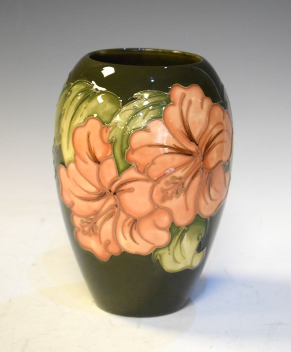 Modern Moorcroft ovoid vase decorated with the Hibiscus pattern on a green ground, 18cm high