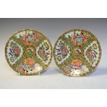 Pair of Cantonese porcelain plates typically decorated with figures on a terrace and foliate