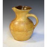 T.W. Lemon Wesuma mottled yellow glazed pottery jug having typical incised decoration, incised marks