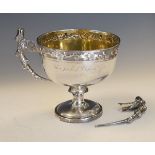 Chinese export silver two handled trophy cup having prunus decoration in low relief, naturalistic