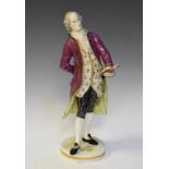 Late 19th Century Continental porcelain figure depicting a standing nobleman reading from a book,