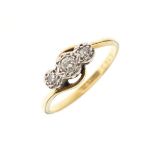 Three stone diamond crossover ring, the yellow metal shank stamped 18ct & Plat, size Q, 3.1g