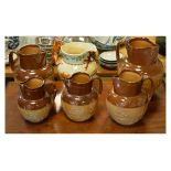 Group of pottery jugs comprising: Crown Devon John Peel relief moulded jug with hunting