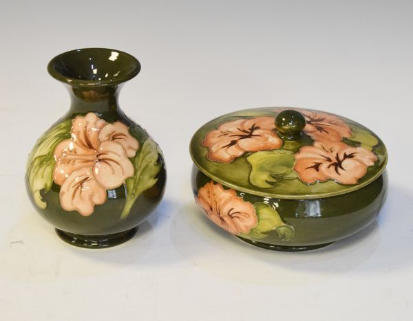 Modern Moorcroft circular bowl and cover decorated with the Hibiscus pattern on a green ground,