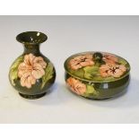 Modern Moorcroft circular bowl and cover decorated with the Hibiscus pattern on a green ground,