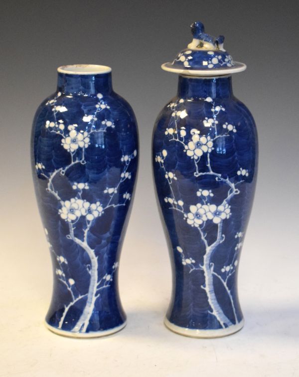 Pair of Chinese blue and white baluster shaped vases, each having prunus decoration on a blue