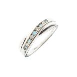 9ct white gold crossover ring set diamonds and pale blue stones, size O, 2.7g approx Condition: