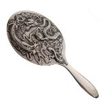 Early 20th Century Chinese export silver backed hand mirror decorated in relief with a dragon