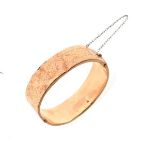 9ct gold snap bangle with engraved decoration, 21.5g approx Condition: