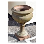 Antique terracotta coloured stoneware garden planter or urn of cauldron form with leaf decoration on