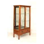 Chinese hardwood display cabinet fitted three shelves enclosed by a pair of bevelled glazed doors,