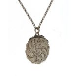 Mid 19th Century silver oval vinaigrette of wavy outline and hinged form enclosing a pierced grille,