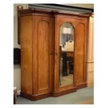 Victorian mahogany breakfront triple wardrobe, the moulded cornice over central mirrored door