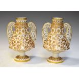 Pair of 19th Century Crown Derby porcelain baluster shaped ivory ground vases, each having gilded