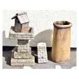 A pale terracotta coloured cylindrical chimney pot, a reconstituted stone birdbath of stepped design