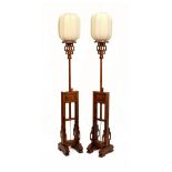 Pair of 20th Century Chinese carved softwood standard lamps, each with 'paper lantern' style