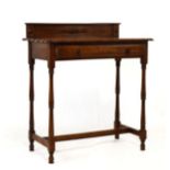 Early 20th Century oak side table with low gallery back over wavy edged top and single frieze drawer