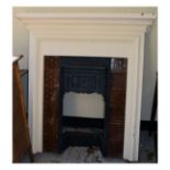 Late Victorian cast iron fireplace with flowerhead motif between treacle glazed brickwork, in