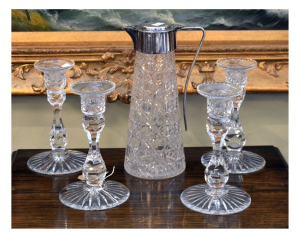 Set of four cut lead crystal table candlesticks, together with a hobnail cut claret jug with