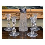 Set of four cut lead crystal table candlesticks, together with a hobnail cut claret jug with