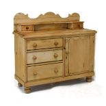 Natural pine low dresser base or chiffonier having a shaped two drawer superstructure over moulded