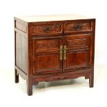 20th Century Chinese stained pine cabinet with cleated top over two drawers and two cupboard doors