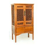 20th Century Chinese stained soft wood cabinet having a pair of cupboard doors with hexagonal and