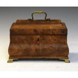 George III mahogany sarcophagus shaped tea caddy standing on brass ogee bracket feet, the hinged