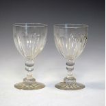 Two large late 19th/early 20th Century cut glass goblets, each having a facet cut bowl, knopped stem