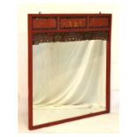 20th Century Chinese red painted and carved overmantel mirror with bevelled rectangular plate