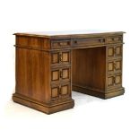 Early 20th Century walnut twin pedestal desk, the rectangular top with gilt tooled skiver, over