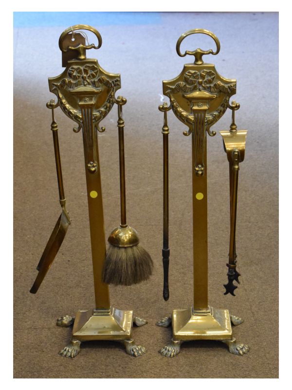 Early 20th Century brass companion set comprising shovel, brush, tongs and poker on a pair of