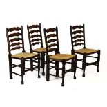 Set of four rush seated ladder back chairs, each with five rung shaped back between turned uprights,