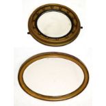 Early 20th Century circular giltwood wall mirror having a bevelled plate within reeded ebonised