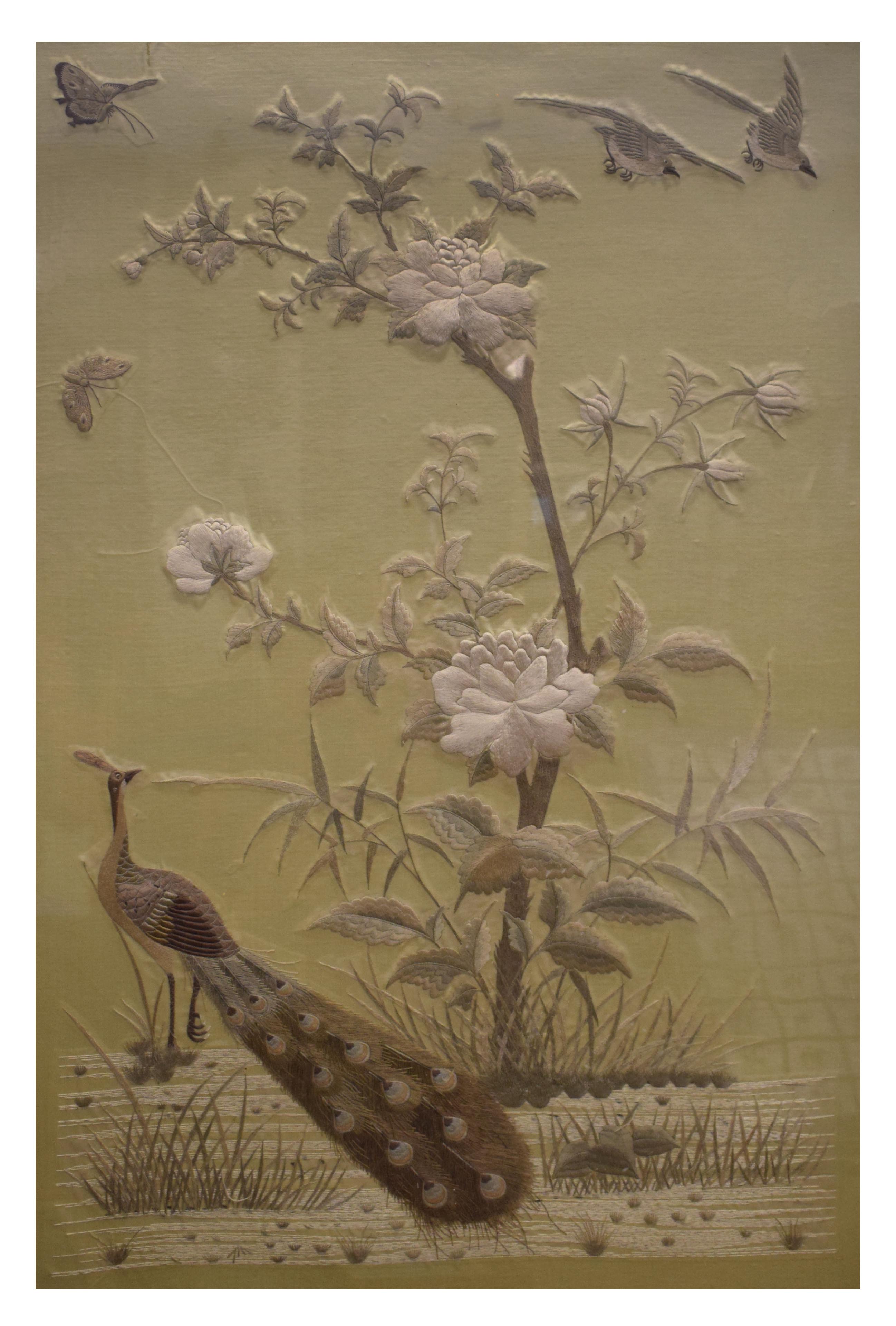 Early 20th Century Oriental embroidered silk panel depicting a peacock in a landscape, 91.5cm x
