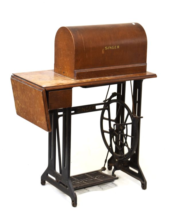 Singer sewing machine on wooden table base with iron treadle Condition: