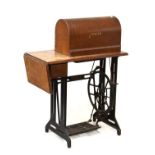 Singer sewing machine on wooden table base with iron treadle Condition: